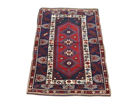 Tappeto caucasico fondo blu, campo con medaglione centrale a quattro losanghe...