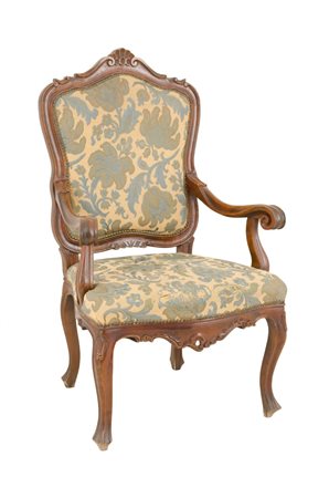 POLTRONA in noce con seduta e spalliera in stoffa a motivo floreale. XX...