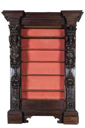 Enorme libreria in noce ricostruita con due grandi erme della fine del sec....