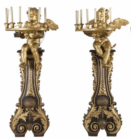 Coppia di torciere barocche in legno intagliato e dorato, putti alati...