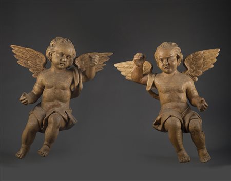 Coppia di sculture in legno raffiguranti putti alati. Sec. XVIII (h. cm 60)...