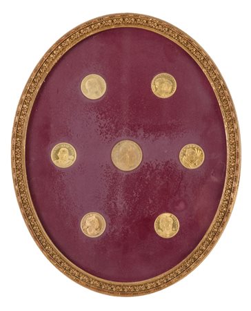 SETTE MONETE in metallo dorato incorniciate. Misure: cm 32 x 26