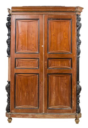 ARMADIO a due ante in pino pece con cariatidi in legno ebanizzato. Sicilia...