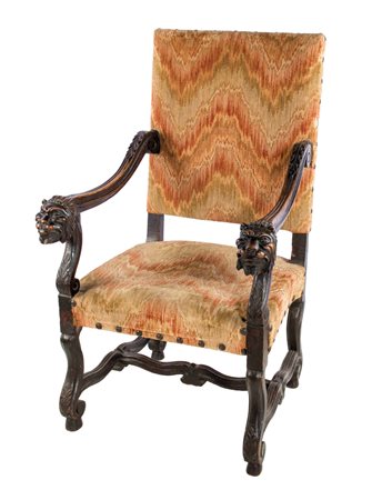 Una poltrona in noce ad “osso di montone” Schienale e seduta imbottiti,...