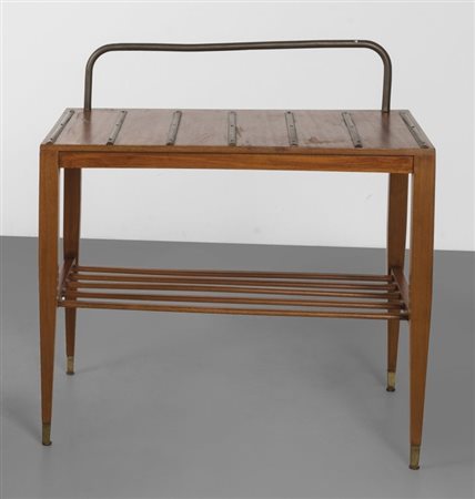 GIO PONTI Un supporto per valigie, 1953. Legno di mogano, ottone. Cm 65 (h) x...