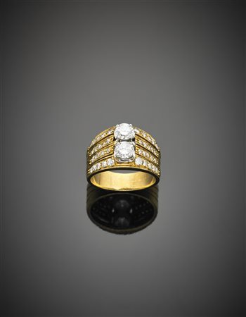 Anello in oro giallo con diamanti rotondi nel gambo ed al centro due più...