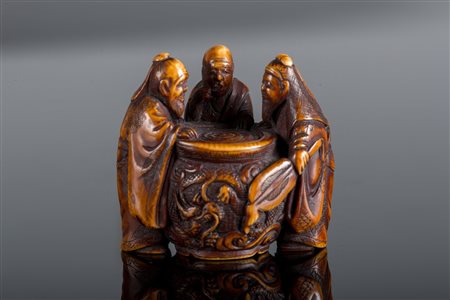 Arte Giapponese Netsuke in avorio raffigurante tre personaggi intorno ad un...